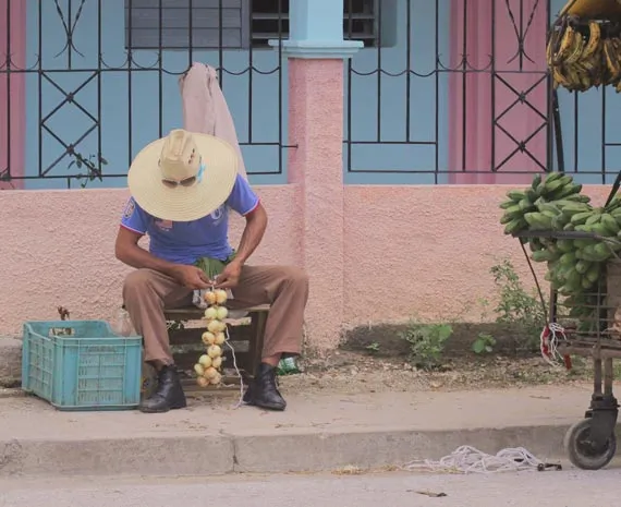 Homme triant des oignons dans la rue à Cuba